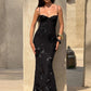 Elegant black fitted dress with appliqué details