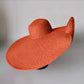 Orange oversized floppy beach hat